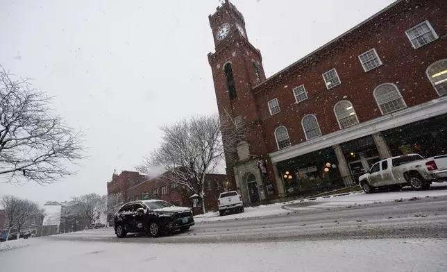People drive around in the snow in Bellows Falls, Vt., on Thursday, April 4, 2024. (Kristopher Radder/The Brattleboro Reformer via AP)