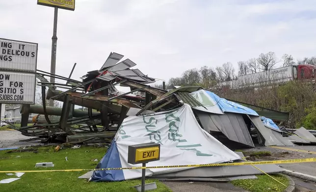 A steel billboard and its support were blown over in Dunbar, W.Va., Tuesday, April 2, 2024, after severe storms blew through the area. (Chris Dorst/Charleston Gazette-Mail via AP)