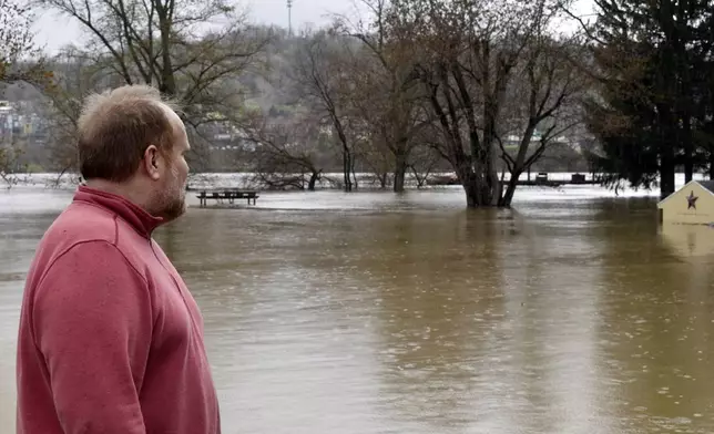 Councilman Ben Seidler, a resident of Wheeling Island, surveys high water near his home as the Ohio River floods its banks, Thursday, April 4, 2024, in Wheeling, W.Va., following days of heavy rains in the region. (Eric Ayres/The Intelligencer via AP)