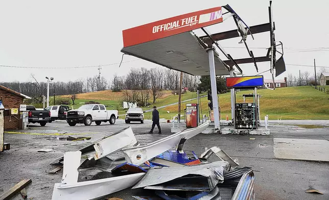The canopy of a gas station is strewn about the ground, Wednesday, April 3, 2024, outside the Par Mar convenience store off Route 60 in Hico, W.Va., after a storm hit the area the night before. (Rick Barbero/The Register-Herald via AP)
