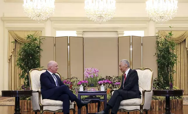 In this photo released by Singapore's Ministry of Communications and Information, New Zealand Prime Minister Luxon, left, chats with Singapore's Prime Minister Lee Hsien Loong at the Istana, Monday, April 15, 2024. (Terence Tan/Ministry of Communications and Information via AP)