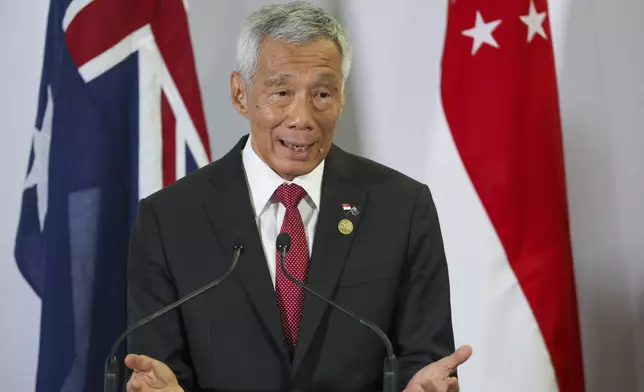 FILE - Singapore Prime Minister Lee Hsien Loong gestures during a joint press conference with Australian Prime Minister Anthony Albanese following a bilateral meeting at the ASEAN-Australia Special Summit in Melbourne, Australia on March 5, 2024. Lee will relinquish his office on May 15 and hand the post to his deputy Lawrence Wong, his office said Monday, April 15, 2024. (AP Photo/Hamish Blair, File)