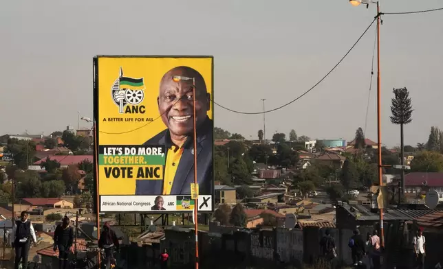 An election poster, with President Cyril Ramaphosa atop a pole in Soweto, South Africa, Monday, April 22, 2024. South Africans celebrate "Freedom Day" every April 27, when they remember their country's pivotal first democratic elections in 1994 that announced the official end of the racial segregation and oppression of apartheid. (AP Photo/Themba Hadebe)