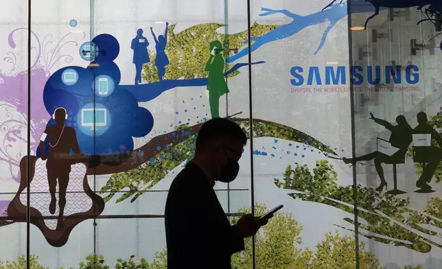A man walks by Samsung Electronics' shop in Seoul, South Korea, Tuesday, April 30, 2024. Samsung Electronics on Tuesday reported a 10-fold increase in operating profit for the last quarter as the expansion of artificial intelligence technologies drives a rebound in the markets for computer memory chips.(AP Photo/Ahn Young-joon)