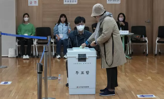 FILE - A woman casts her vote for the parliamentary election at a polling station in Seoul, South Korea, Wednesday, April 10, 2024. South Korean voters have handed liberals extended opposition control of parliament in what looks like a massive political setback to conservative President Yoon Suk Yeol. Some experts say the results of Wednesday’s parliamentary elections make Yoon “a lame duck” — or even “a dead duck” — for his remaining three years in office. Others disagree, saying Yoon still has many policy levers and could aggressively push his foreign policy agenda. (AP Photo/Ahn Young-joon, File)