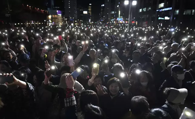 FILE - Supporters of South Korea's ruling People Power Party flash their smartphones' lights during the party's parliamentary election campaign in Seoul, South Korea, Tuesday, April 9, 2024. South Korean voters have handed liberals extended opposition control of parliament in what looks like a massive political setback to conservative President Yoon Suk Yeol. Some experts say the results of Wednesday’s parliamentary elections make Yoon “a lame duck” — or even “a dead duck” — for his remaining three years in office. Others disagree, saying Yoon still has many policy levers and could aggressively push his foreign policy agenda. (AP Photo/Lee Jin-man, File)