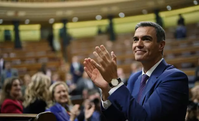 FILE, Spain's acting Prime Minister Pedro Sanchez applauds he was chosen by a majority of legislators to form a new government after a parliamentary vote at the Spanish Parliament in Madrid, Spain, Thursday, Nov. 16, 2023. Sánchez says he will continue in office "even with more strength" after days of reflection. Sánchez shocked the country last week when he said he was taking five days off to think about his future after a court opened preliminary proceedings against his wife on corruption allegations. (AP Photo/Manu Fernandez, File)