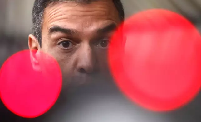 FILE. Spain's Prime Minister Pedro Sanchez speaks on camera as he arrives for an EU summit at the European Council building in Brussels, Thursday, Oct. 1, 2020. Sánchez says he will continue in office "even with more strength" after days of reflection. Sánchez shocked the country last week when he said he was taking five days off to think about his future after a court opened preliminary proceedings against his wife on corruption allegations. (AP Photo/Francisco Seco, File)