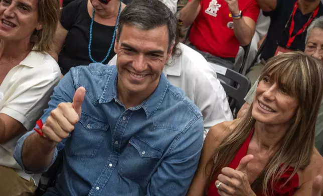 FILE - Spain's Prime Minister Pedro Sanchez next to his wife Begona Gomez, gives a thumb up during a campaign closing meeting in Madrid, Spain, Friday, July 21, 2023. Spain is in nail-biting suspense Monday as it waits for Prime Minister Pedro Sanchez to announce whether he will continue in office or not. Sanchez, 52, shocked the country on Thursday, announcing he was taking five days off to think about his future after a court opened preliminary proceedings against his wife on corruption allegations. (AP Photo/Emilio Morenatti, File)