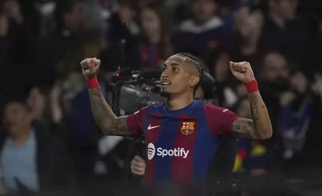Barcelona's Raphinha celebrates after scoring his side's opening goal during the Champions League quarterfinal second leg soccer match between Barcelona and Paris Saint-Germain at the Olimpic Lluis Companys stadium in Barcelona, Spain, Tuesday, April 16, 2024. (AP Photo/Emilio Morenatti)