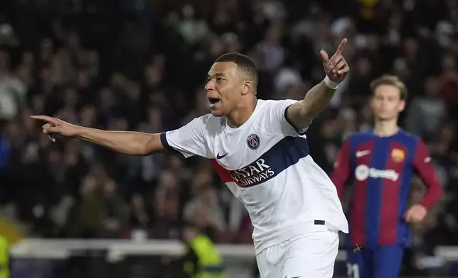 PSG's Kylian Mbappe celebrates after scoring his side's third goal during the Champions League quarterfinal second leg soccer match between Barcelona and Paris Saint-Germain at the Olimpic Lluis Companys stadium in Barcelona, Spain, Tuesday, April 16, 2024. (AP Photo/Emilio Morenatti)
