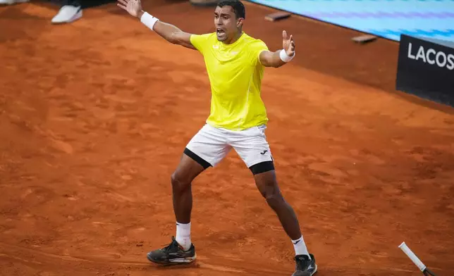 Thiago Monteiro, of Brazil, reacts during a match against Stefanos Tsitsipas, of Greece, during the Mutua Madrid Open tennis tournament in Madrid, Saturday, April 27, 2024. (AP Photo/Manu Fernandez)