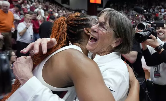 FILE - Stanford head coach Tara VanDerveer, right, is congratulated by forward Kiki Iriafen after breaking the college basketball record for wins, 1,203, following her team's win over Oregon State in an NCAA college basketball game, Sunday, Jan. 21, 2024, in Stanford, Calif. VanDerveer, the winningest basketball coach in NCAA history, announced her retirement Tuesday night, April 9, 2024, after 38 seasons leading the Stanford women’s team and 45 years overall. (AP Photo/Godofredo A. Vásquez, File)