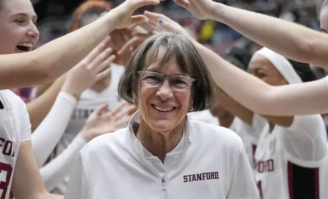 FILE - Stanford coach Tara VanDerveer smiles as players celebrate her 1,202nd victory as a college coach following an NCAA basketball game against Oregon, Friday, Jan. 19, 2024, in Stanford, Calif. VanDerveer, the winningest basketball coach in NCAA history, announced her retirement Tuesday night, April 9, 2024, after 38 seasons leading the Stanford women’s team and 45 years overall. (AP Photo/Tony Avelar, File)