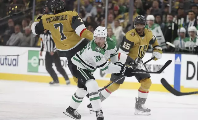 Dallas Stars center Ty Dellandrea (10) checks Vegas Golden Knights defenseman Alex Pietrangelo (7) during the first period in Game 4 of an NHL hockey Stanley Cup first-round playoff series Monday, April 29, 2024, in Las Vegas. (AP Photo/Ian Maule)