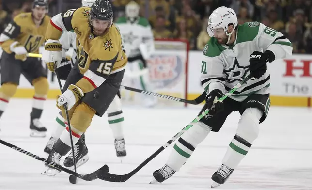 Vegas Golden Knights defenseman Noah Hanifin (15) skates past Dallas Stars center Tyler Seguin (91) during the first period in Game 3 of an NHL hockey Stanley Cup first-round playoff series Saturday, April 27, 2024, in Las Vegas. (AP Photo/Ian Maule)