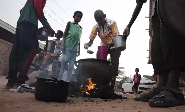 FILE - People prepare food in a Khrtoum neighborhood on June 16, 2023. Sudan has been torn by war for a year now, torn by fighting between the military and the notorious paramilitary Rapid Support Forces. (AP Photo, File)