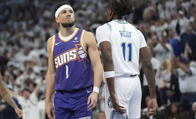 Phoenix Suns guard Devin Booker (1) stands on the court during the second half of Game 1 of an NBA basketball first-round playoff series against the Minnesota Timberwolves, Saturday, April 20, 2024, in Minneapolis. (AP Photo/Abbie Parr)
