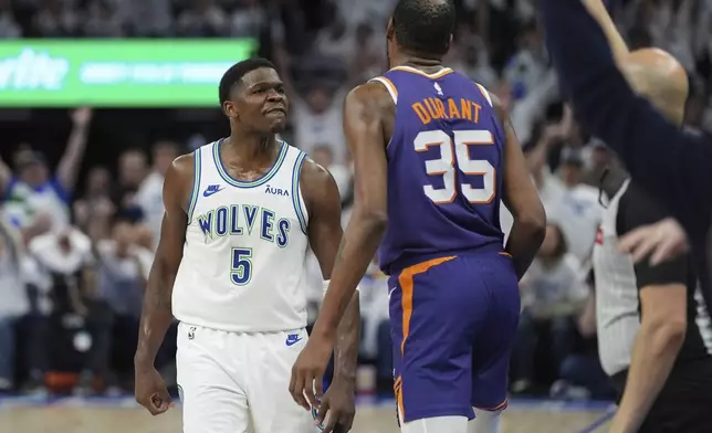 Minnesota Timberwolves guard Anthony Edwards (5) celebrates toward Phoenix Suns forward Kevin Durant (35) after making a 3-point shot during the second half of Game 1 of an NBA basketball first-round playoff series, Saturday, April 20, 2024, in Minneapolis. (AP Photo/Abbie Parr)