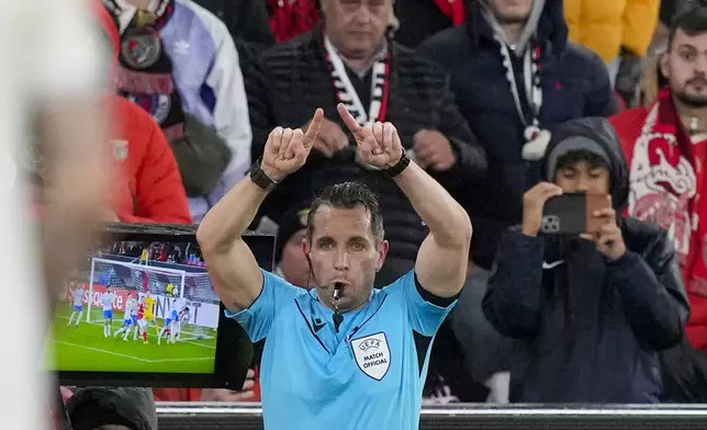 FILE - Referee Tobias Stieler calls a penalty for Benfica after consulting VAR during the Europa League round of 16, first leg, soccer match between SL Benfica and Rangers FC at the Luz stadium in Lisbon, March 7, 2024. Swedish soccer has adopted an isolationist stance in eschewing technology to retain a pure version of the beautiful game. Sweden is the only one of Europe's top-30 ranked leagues yet to have rolled out VAR in its domestic competitions. (AP Photo/Armando Franca, File)