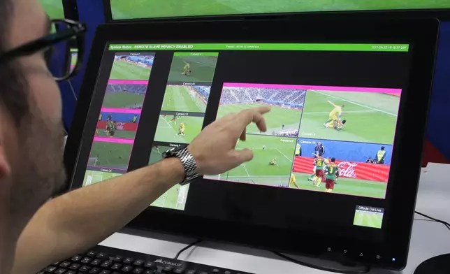 FILE - A referee demonstrates a video operation room, a facility of the Video Assistant Referee (VAR) system which will be rolled out for the first time during the World Cup, in Moscow, Russia, on June 9, 2018. VAR - the high-tech video review system formally written into the laws of soccer in 2018 to, in theory, help referees make the right calls in the biggest moments. (AP Photo/Dmitri Lovetsky, File)