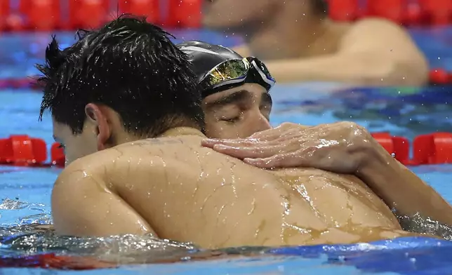 FILE - United States' Michael Phelps congratulates Singapore's gold medal winner Joseph Schooling after the men's 100-meter butterfly final during the swimming competitions at the 2016 Summer Olympics, in Rio de Janeiro, Brazil on Aug. 12, 2016. Schooling, who beat Phelps to win Singapore's first and only Olympic gold medal at Rio de Janeiro in 2016, announced his retirement, Tuesday, April 2, 2024. (AP Photo/Lee Jin-man, File)