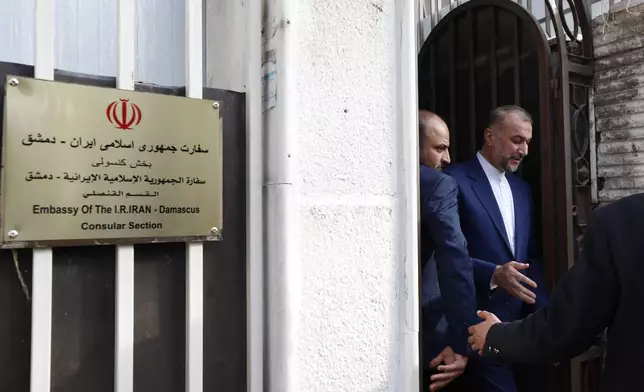 Iranian Foreign Minister Hossein Amirabdollahian, right, leaves after the opening of the new Iranian consulate building in Damascus, Syria, Monday, April 8, 2024. Iran's foreign minister Monday accused the United States of giving Israel the "green light" to strike the consulate building in Syria that killed seven Iranian military officials including two generals. (AP Photo/Omar Sanadiki)