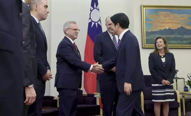In this photo released by the Taiwan Presidential Office, Mark Alford, center left, a member of the House Armed Services Committee shakes hands with Taiwan President-elect and Vice President Lai Ching-te in Taipei, Taiwan on Tuesday, April 23, 2024. Lisa McClain, secretary-general of the Republican Caucus of the U.S. House of Representatives and Democratic Congressman Dan Kildee jointly led a cross-party group of lawmakers to visit Taiwan from April 23 to 25 . Members also include Mark Alford, a member of the House Armed Services Committee. (Taiwan Presidential Office via AP)