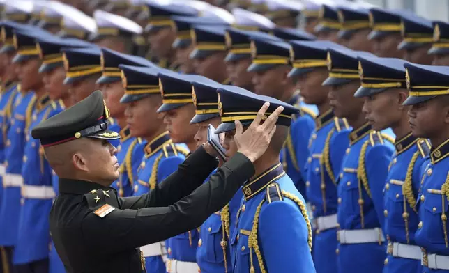 A Thai soldier checks royal guards before a welcome ceremony for New Zealand's Prime Minister Christopher Luxon in Bangkok, Thailand, Wednesday, April 17, 2024. (AP Photo/Sakchai Lalit)