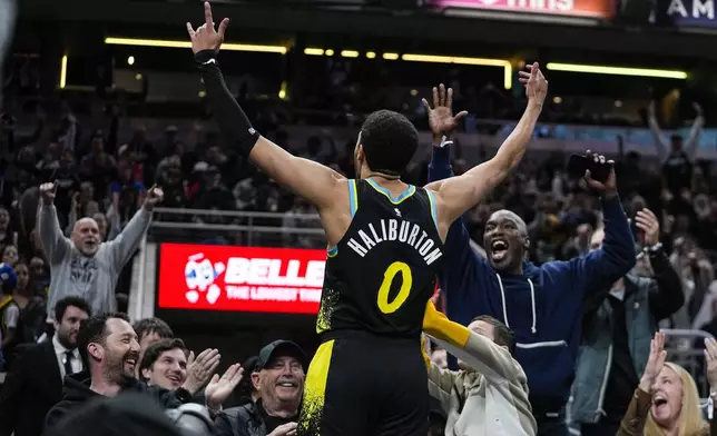 Indiana Pacers guard Tyrese Haliburton (0) celebrates after hitting a three-point basket against the Oklahoma City Thunder at the end of the third quarter in an NBA basketball game in Indianapolis, Friday, April 5, 2024. (AP Photo/Darron Cummings)