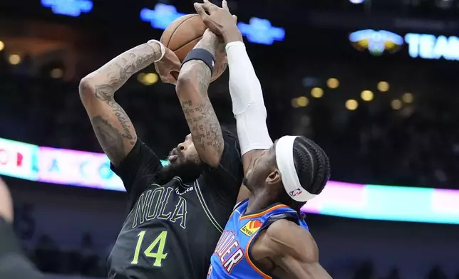 Oklahoma City Thunder guard Shai Gilgeous-Alexander tries to block the shot of New Orleans Pelicans forward Brandon Ingram (14) in the first half of Game 4 of an NBA basketball first-round playoff series in New Orleans, Monday, April 29, 2024. (AP Photo/Gerald Herbert)