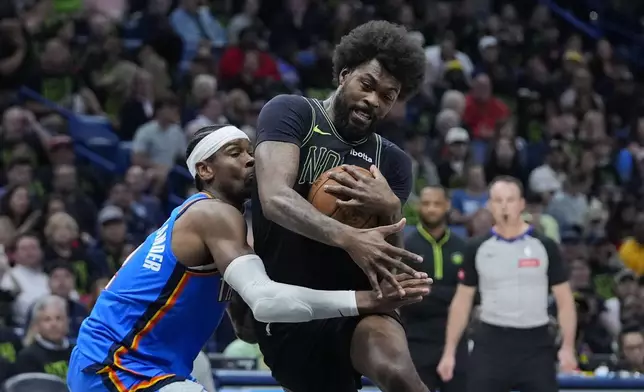 Oklahoma City Thunder guard Shai Gilgeous-Alexander defends as New Orleans Pelicans forward Naji Marshall drives to the basket in the first half of Game 4 of an NBA basketball first-round playoff series in New Orleans, Monday, April 29, 2024. (AP Photo/Gerald Herbert)