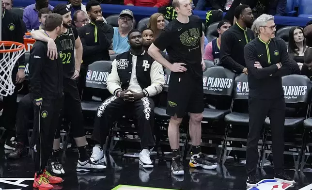 New Orleans Pelicans forward Zion Williamson, in street clothes due to an injury, watches as he sits on the bench in the waning moments of the second half of Game 4 of an NBA basketball first-round playoff series against the Oklahoma City Thunder in New Orleans, Monday, April 29, 2024. The Thunder won 97-89 to sweep the series and advance to the second round. (AP Photo/Gerald Herbert)
