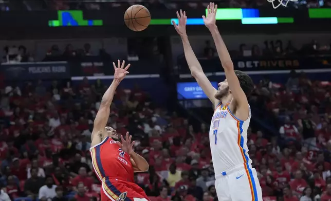 New Orleans Pelicans guard CJ McCollum (3) shoots against Oklahoma City Thunder forward Chet Holmgren (7) in the first half of Game 3 of an NBA basketball first-round playoff series in New Orleans, Saturday, April 27, 2024. (AP Photo/Gerald Herbert)