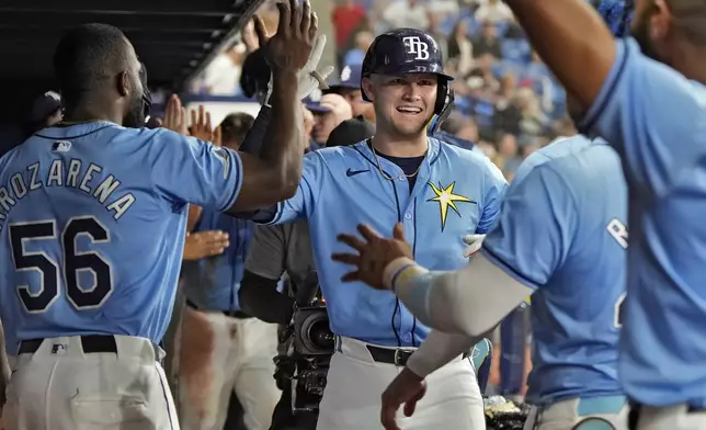 Tampa Bay Rays' Curtis Mead, of Australia, center, celebrates in the dugout after his two-run home run off Detroit Tigers relief pitcher Will Vest during the sixth inning of a baseball game Wednesday, April 24, 2024, in St. Petersburg, Fla. (AP Photo/Chris O'Meara)