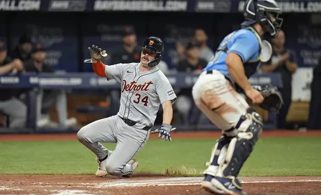 Detroit Tigers' Jake Rogers (34) scores around Tampa Bay Rays catcher Ben Rortvedt on a two-run single by Mark Canha during the fifth inning of a baseball game Wednesday, April 24, 2024, in St. Petersburg, Fla. (AP Photo/Chris O'Meara)