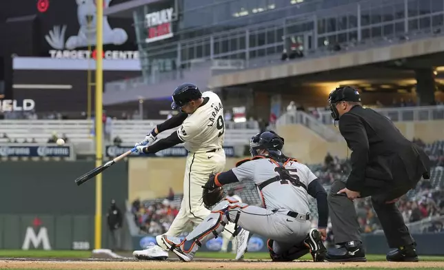 Minnesota Twins' Trevor Larnach (9) hits a two-run home run against the Detroit Tigers during the first inning of a baseball game Friday, April 19, 2024, in Minneapolis. (AP Photo/Abbie Parr)