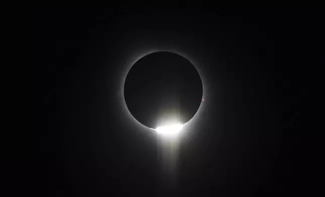 The sun begins to peak back out from behind the moon as totality ends during a total solar eclipse on Monday, April 8, 2024, in Hot Springs National Park, Ark. (AP Photo/Nick Ingram)
