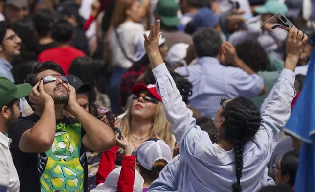 People watch a total solar eclipse in Mazatlan, Mexico, Monday, April 8, 2024. (AP Photo/Fernando Llano)