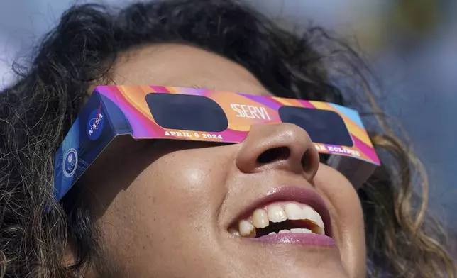 People use special glasses to watch a total solar eclipse in Mazatlan, Mexico, Monday, April 8, 2024. (AP Photo/Fernando Llano)