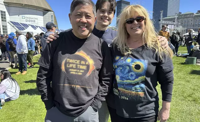 Anthony Tam shows off his "Twice in a Lifetime" shirt at the Great Lakes Science Center in Cleveland, Sunday, April 7, 2024. He saw the 2017 eclipse in Casper, Wyo., and came to Cleveland with his wife, Tamara, from Los Angeles because his son Joshua is a college student here. "It was beautiful," he said of the 2017 eclipse. "The most beautiful thing I've seen with my own eyes." (AP Photo/Stephanie Nano)