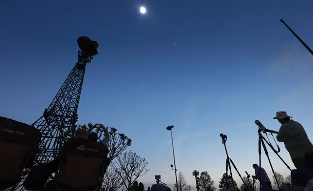 A total solar eclipse is shown over the Paris Eiffel Tower in Paris, Texas, Monday, April 8, 2024. (AP Photo/Tony Gutierrez)