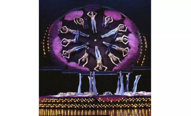 FILE - In this April 14, 1997, file photo, showgirls perform one of their acts during a dress rehearsal for the new edition of "The Best of the Folies Bergere...Sexier Than Ever" show at the Tropicana Resort and Casino in Las Vegas. (AP Photo/Lennox McLendon, file)