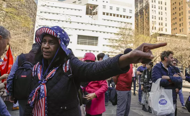 A supporter for former President Donald Trump, who only identified herself as Sophia, demonstrates outside Manhattan criminal court, Monday, April 15, 2024, in New York. The hush money trial of Trump begins Monday with jury selection. It's a singular moment for American history as the first criminal trial of a former U.S. commander in chief. (AP Photo/Stefan Jeremiah)