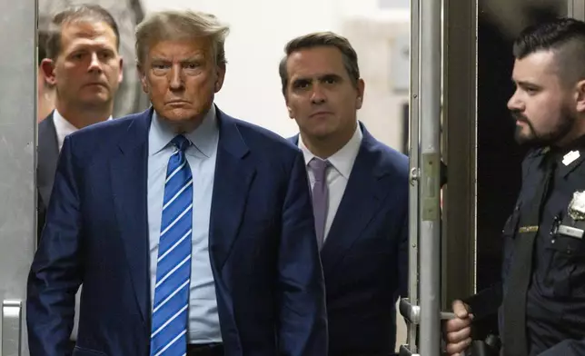 Former President Donald Trump walks through a doorway during the second day of jury selection, Tuesday, April 16, 2024, at Manhattan criminal court in New York. Trump is charged with falsifying business records to cover up a sex scandal during his 2016 campaign. (Justin Lane/Pool Photo via AP)