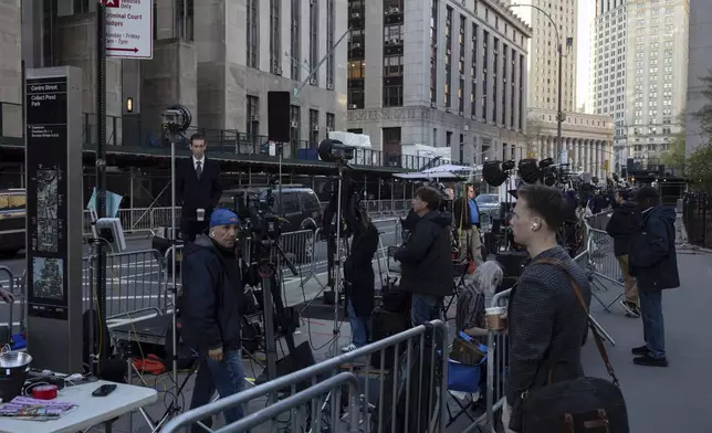 Members of the media gather outside Manhattan Criminal Court, Tuesday, April 16, 2024, in New York. Former President Donald Trump will return to court as a judge works to find a panel of jurors who will decide whether the former president is guilty of criminal charges alleging he falsified business records to cover up a sex scandal during the 2016 campaign. (AP Photo/Yuki Iwamura)
