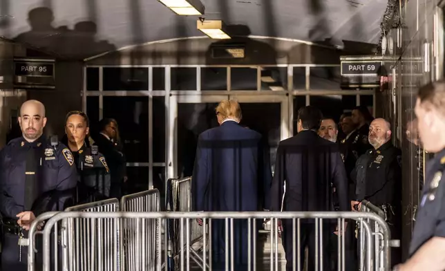 Former President Donald Trump, center, alongside his attorney Todd Blanche, right, leave following proceedings in his trial, Friday, April 19, 2024, at Manhattan Criminal Court in New York. (Mark Peterson/Pool Photo via AP)