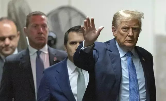 Former President Donald Trump waves to the media as he returns from a break during his trial at Manhattan criminal court , Friday, April 26, 2024, in New York. (Jeenah Moon/Pool Photo via AP)