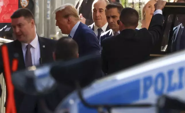 Former President Donald Trump, second from left, arrives at Manhattan criminal court, Tuesday, April 16, 2024, in New York. Donald Trump returned to a New York courtroom Tuesday as a judge works to find a panel of jurors who will decide whether the former president is guilty of criminal charges alleging he falsified business records to cover up a sex scandal during the 2016 campaign. (AP Photo/Yuki Iwamura)