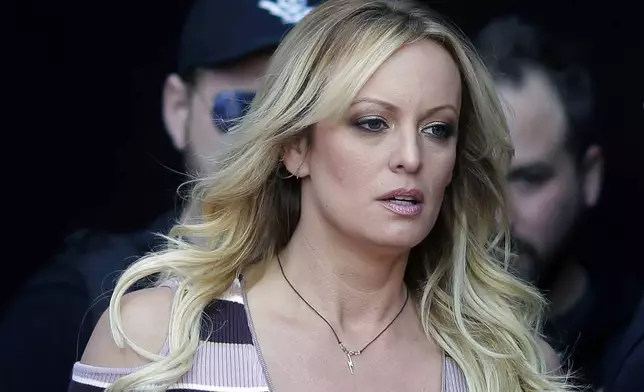 FILE - Adult film actress Stormy Daniels arrives at an event in Berlin, on Oct. 11, 2018. Donald Trump will make history as the first former president to stand trial on criminal charges when his hush money case opens with jury selection. The allegations focus on payoffs to two women, Daniels, a porn actress, and Playboy model Karen McDougal, who said they had extramarital sexual encounters with Trump years earlier, as well as to a Trump Tower doorman who claimed to have a story about a child he alleged Trump had out of wedlock. (AP Photo/Markus Schreiber, File)